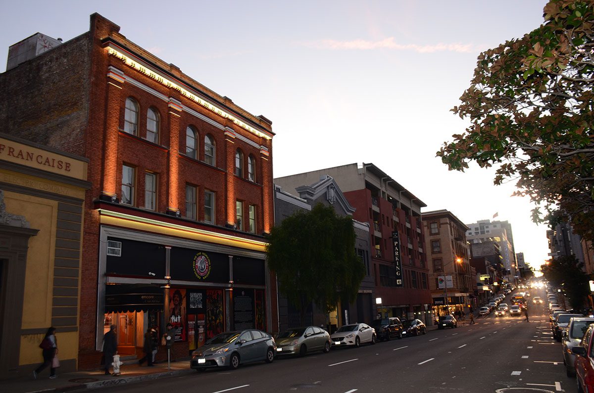 a street with a brick building on the left